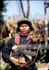 Khmer Rouge girl fighter called 'mit naree' carries an AK47 assault rifle in the jungle of western Cambodia, 15th February 1981. (Photo by Alex Bowie/Getty Images)